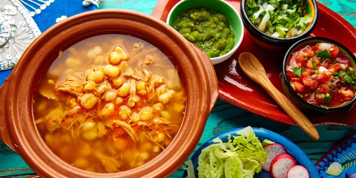 Red pozole brod Mexican cuisine, corn, soup, condiment